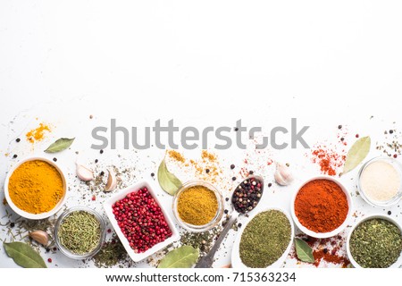 Various spices in a bowls on white background. Top view with copy space. Royalty-Free Stock Photo #715363234