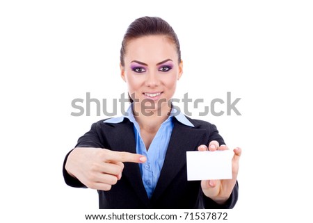 Portrait of a smiling young woman pointing at blank card in her hand against white background