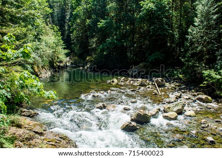 South Fork Snoqualmie River: A view of the South Fork Snoqualmie River in the Twin Falls Natural Area. Royalty-Free Stock Photo #715400023