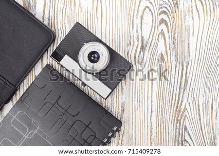 Camera tablet notebook on white wooden background isolation