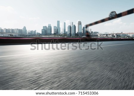 blurry empty asphalt road with road sign and cityscape of chongqing in blue cloud sky