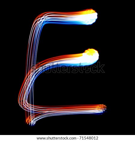 E - Created by light colorful letters over black background