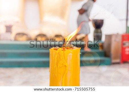 yellow candle burn on fire in the temple for pray