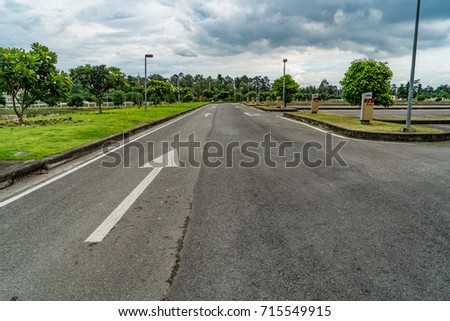 Asphalt road with white arrow sign