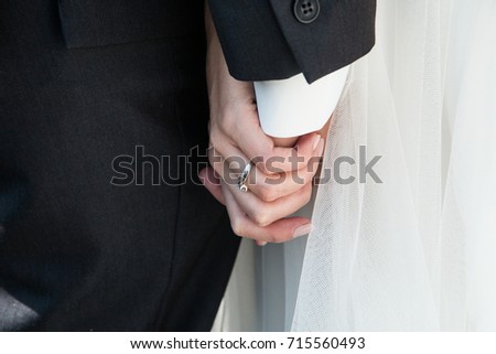 A detail picture from the wedding. The pair is holding their hands. A symbol of their love. 