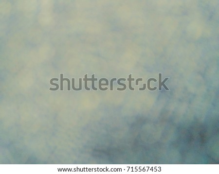 blurred shark in an ocean with yellow white sunlight