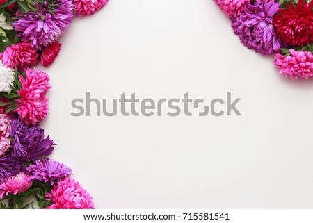 Spring flowers. Pink flowers on white wooden background. Flat lay, top view.