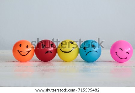 Emotions balls background, Happy Smiley faces ball in yellow , orange and pink. Sadness ball in blue and madness ball in red. Self made hand draw balls. Royalty-Free Stock Photo #715595482