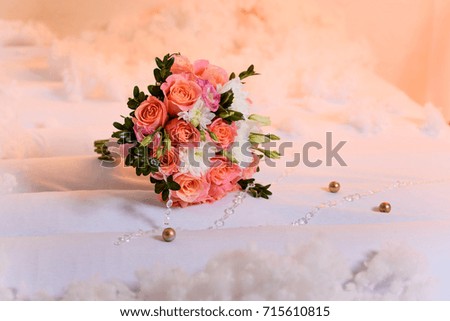 bouquet of roses lies on a pink background.