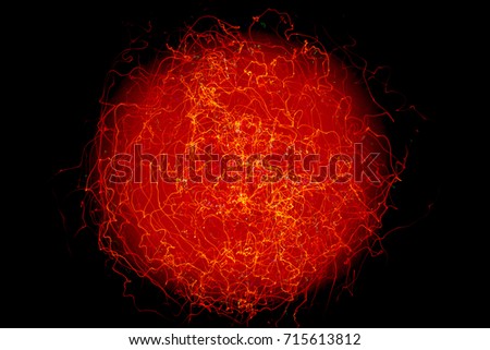 Light ball made by long exposure looks like an abstract cosmic star. Illustration of red giant star or quantum fluctuations of particles.