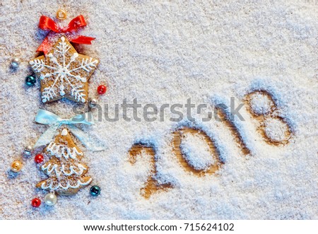 Christmas cookies on snowy background with inscription 2018. Merry Christmas and Happy New Year!! Top view. High resolution product