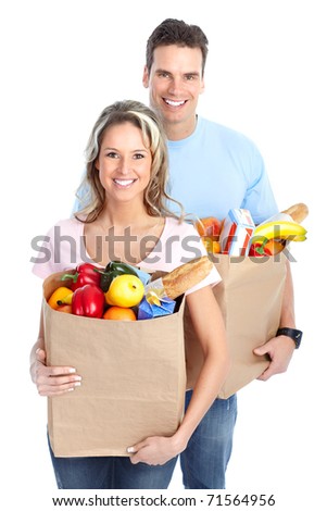 Happy young couple carrying shopping bags with food