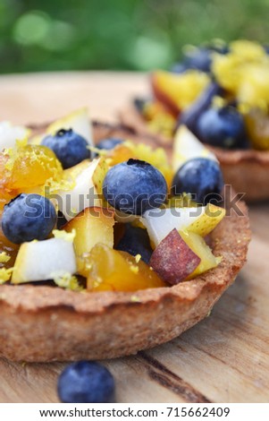 Autumn season baking. Mini tarts from rye flour with fresh fruit filling. Soft focus.  Lost weight concept, diet food.