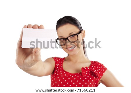 smiling young woman in red dress showing a card . focus in the business card