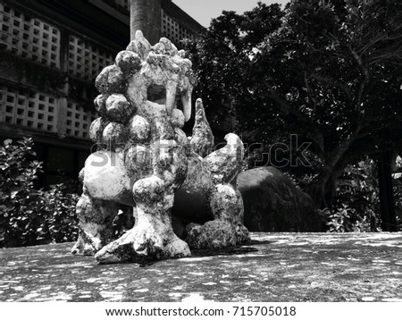 Lion statue in Japan, it is a resembling a cross between a lion and a dog, believed to protect from some evils. People place pairs on their rooftops or flanking the gates to their houses.