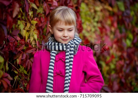 Portrait of cute girl having fun in autumn park