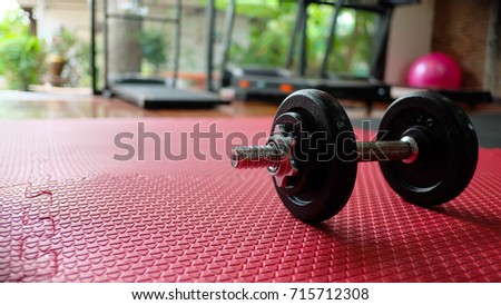Black dumbbell with fitness gym background Royalty-Free Stock Photo #715712308