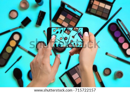 Young woman taking photo to cosmetics with cell phone or smartphone digital camera for post to sell online on the internet.