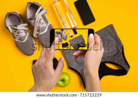 Sport equipment photographing on mobile phone. Smartphone screen with fitness tools image