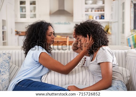 Mother Talking With Unhappy Teenage Daughter On Sofa Royalty-Free Stock Photo #715726852