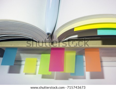 Books with colorful post-it notes

