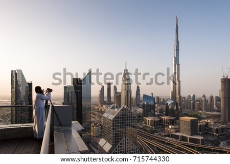 A photographer looks over Dubai city