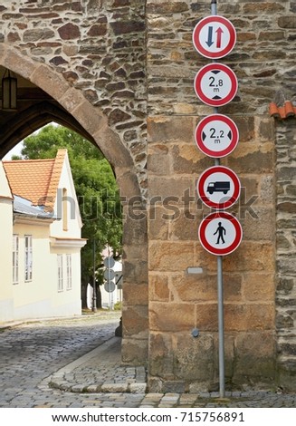 Traffic signs at the entrance gate to the historic city center.                               