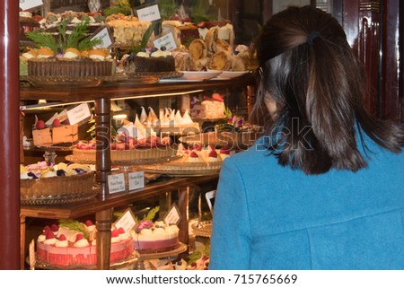 People photographing sweets and cakes stand 