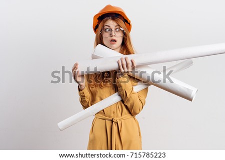 builder woman in an orange helmet on a light background, design, construction                               