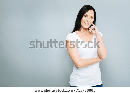 Thoughtful woman touching her cheek