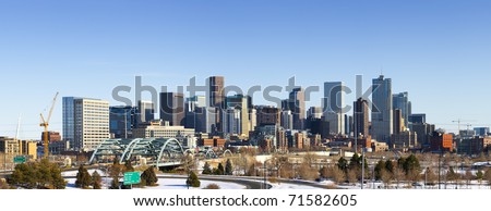 Denver Colorado city skyline from west side of town. Snow covered ground winter.
