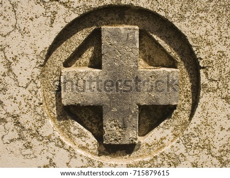 A cross on a gravestone 