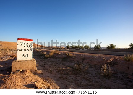Road Sign to Ouarzazate in Morocco with blue sky