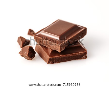 Macro photo  of Chocolate bar. Broken pieces over white background Royalty-Free Stock Photo #715930936