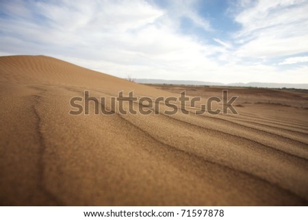 Sahara desert close to Merzouga in Morocco with blue sky and clouds