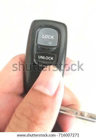 Hand holding key remote.