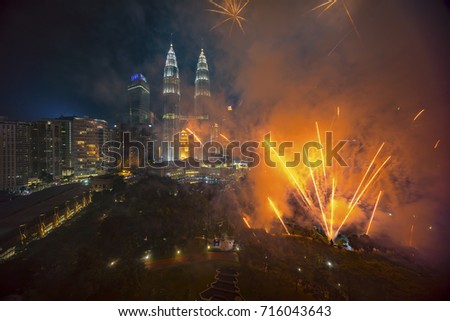 Fireworks display show over Kuala Lumpur city skyline Royalty-Free Stock Photo #716043643