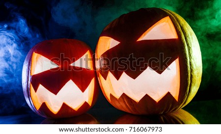 Glowing pumpkins for Halloween on black background