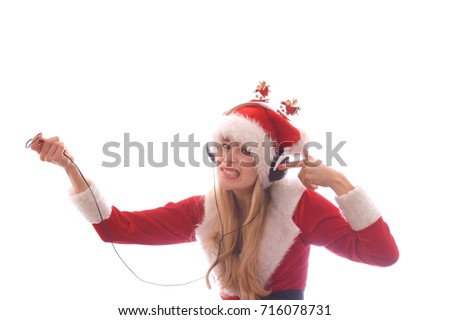 A young girl dresses up as Santa Claus and wants to hear Christmas music.
She wears headphones on her head and notices that she has no power
and no music.