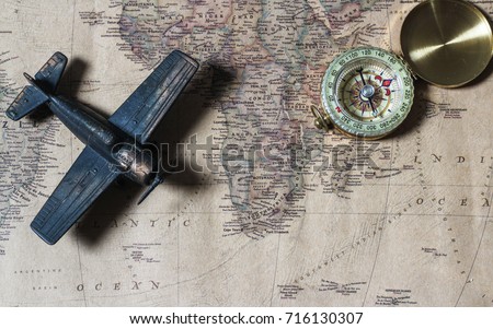compass over map with  toy airplane,abstract background to travel concept.