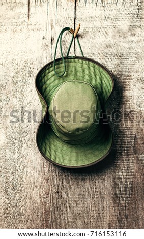 The green Ranger's hat on wooden background