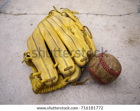 Photo of a baseball gloves and an old baseball