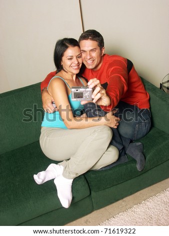 Young adult couple taking a picture together.