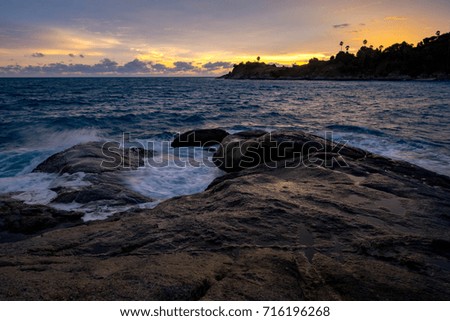 Scenic Skyline View with Spectacular Clouds and Twilight at Sunset Time on Islands with Long Exposure of Waves and Rocks, Phuket, Thailand.