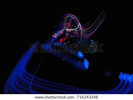 Beautiful Abstract futuristic background color texture with lighting effect. Modern dynamic shiny pattern. Fractal graphic artwork design. Creative long exposure photography. Abstract lights at night.
