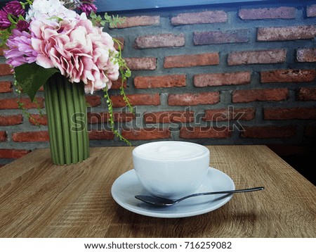 Coffee cup and saucer on a wooden table. nature background.