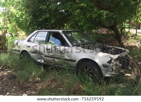 Old Rusted Car Wreck in Junk Yard  Royalty-Free Stock Photo #716259592