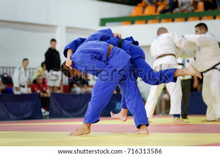 Two judokas in blue judo kimonos fighting