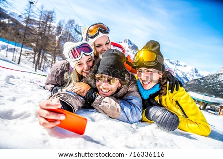 Group of friends with ski on winter holidays - Skiers having fun on the snow