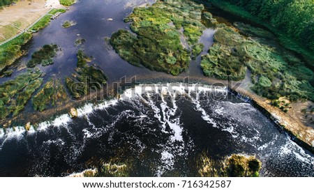 Venta Rapid waterfall, the widest waterfall in Europe, Kuldiga, Latvia. Captured from above. Royalty-Free Stock Photo #716342587